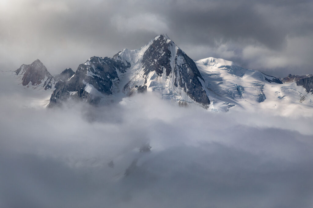 massive mountain breaks through clouds