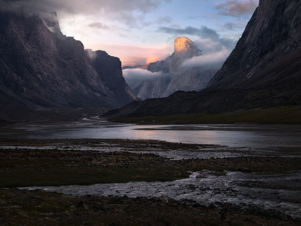 Mount Thor lit at sunset amid arctic mountain peaks