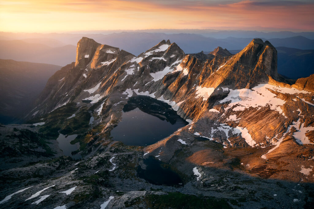 Mountain peaks and alpine lakes in sunrise light