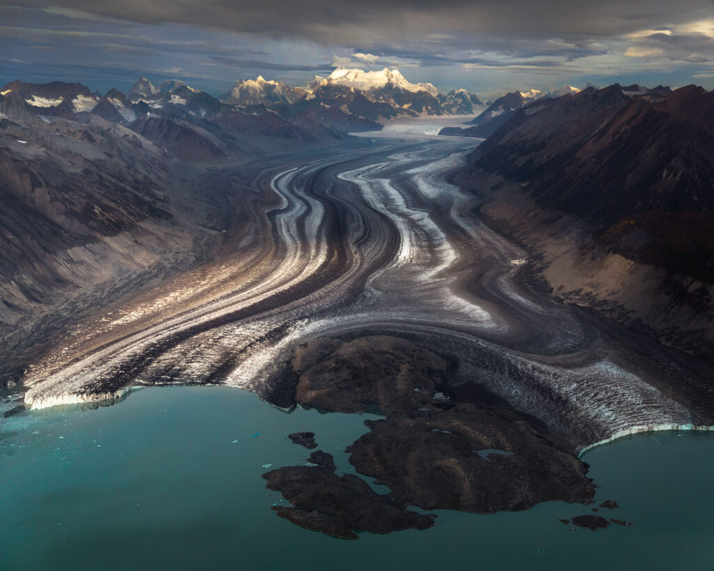 glacier ending in small green lake