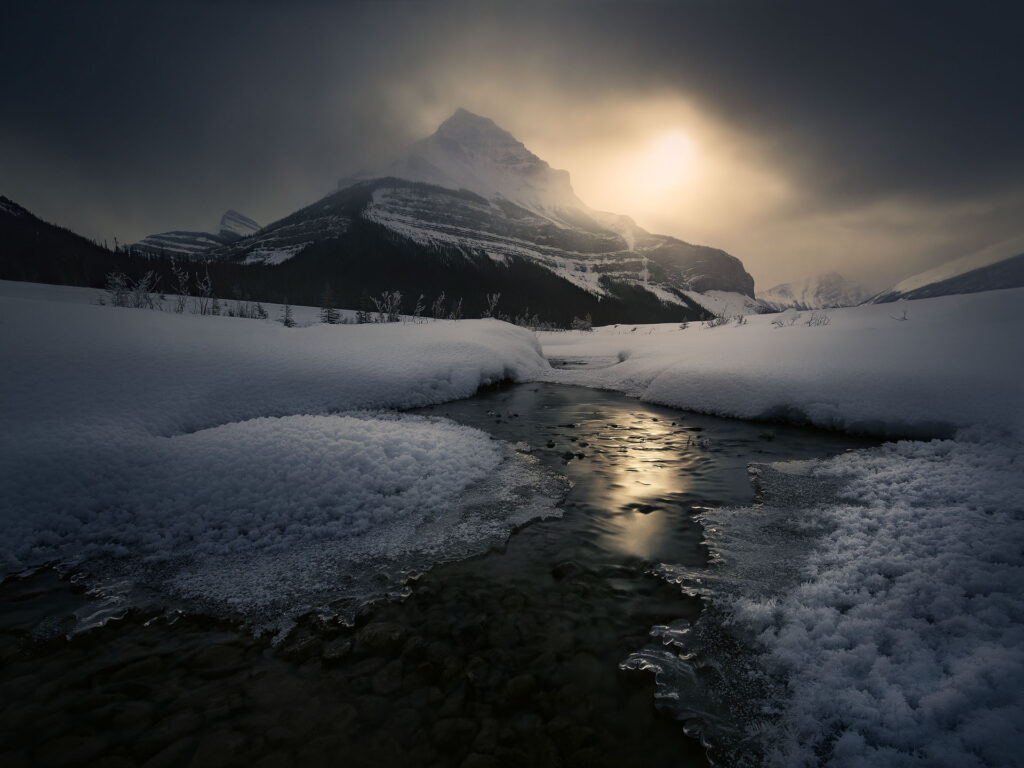 Moonlight over snowy tangle mountain in Jasper National Park