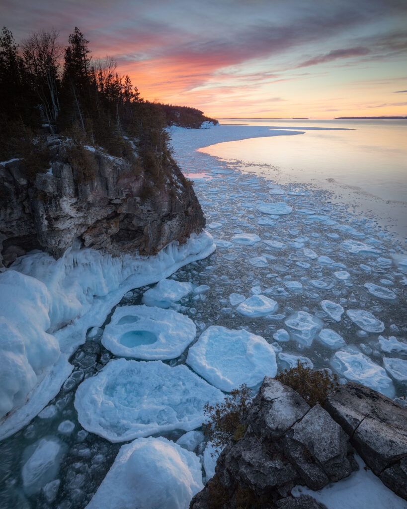 ice breakup under cliffs at sunset