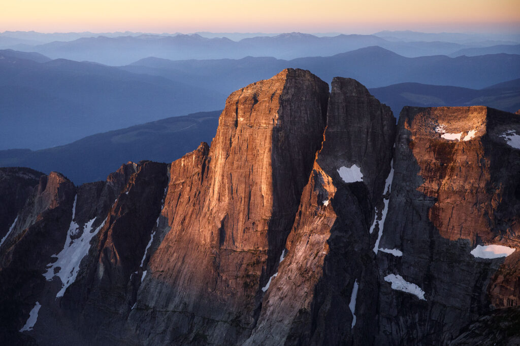 Mountain rising through dawn mist in sunrise light