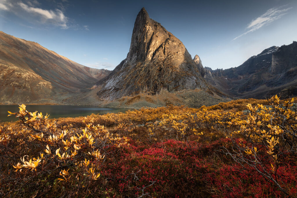 dramatic mountain peak rising over fall colour