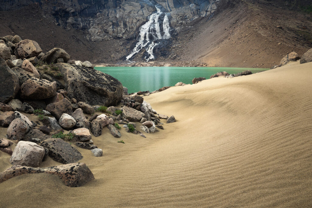 flowing sand leads to a waterfall in the arctic