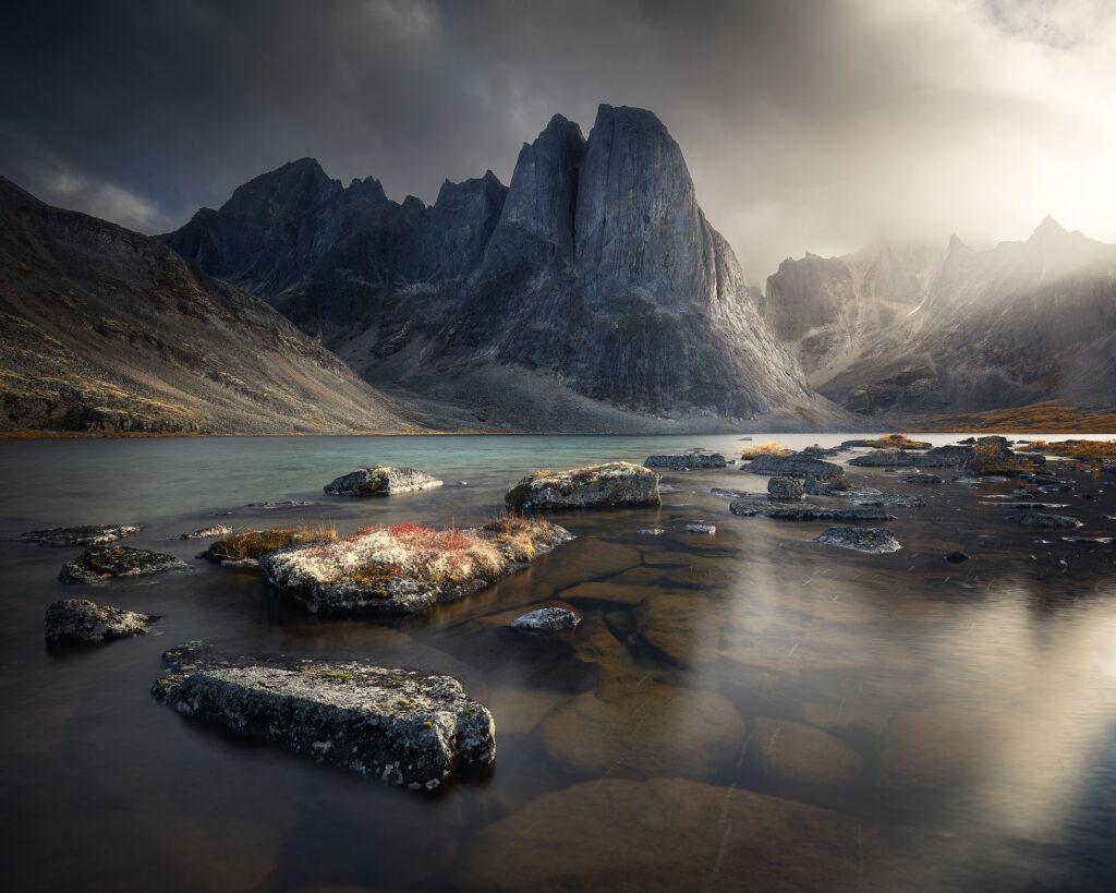 Northern mountain over green stormy lake