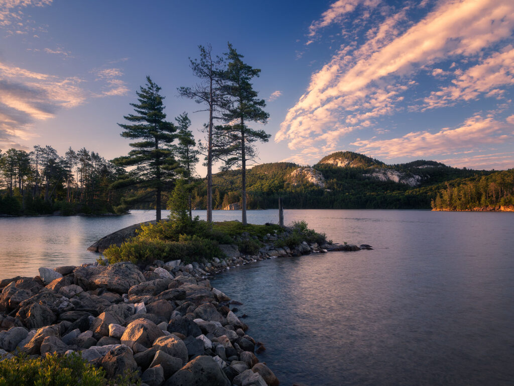 Sunrise over small island and quartzite cliffs