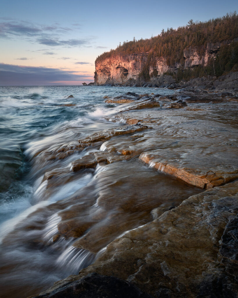 rushing water under cliff flowing on shoreline of bruce peninsula national park