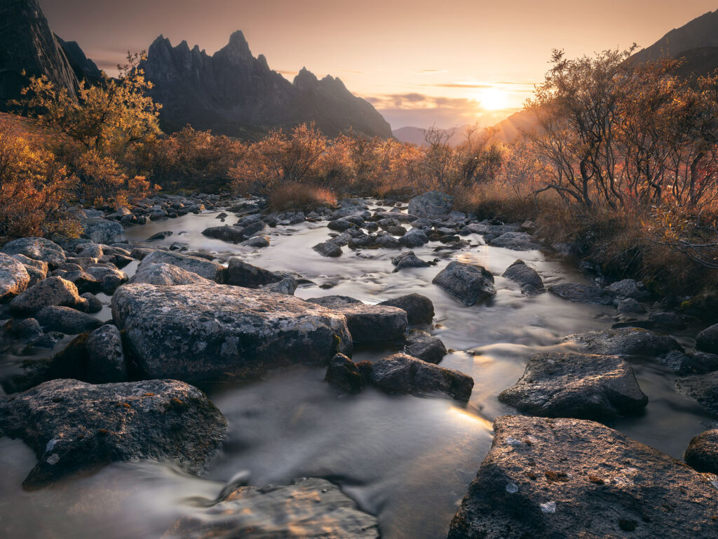 tombstone mountain over a river with lovely fall colour