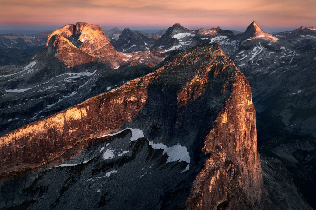 three mountain peaks in sunrise light