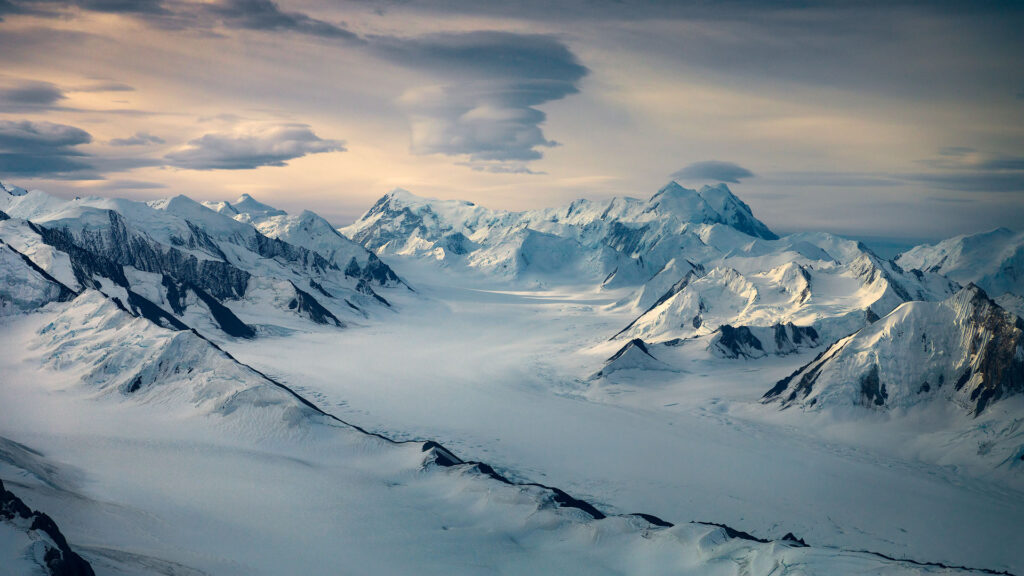 snowy valley and mountains over glaciers