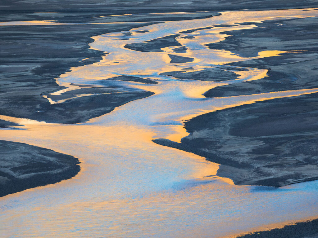 reflected light on a meandering river in the arctic