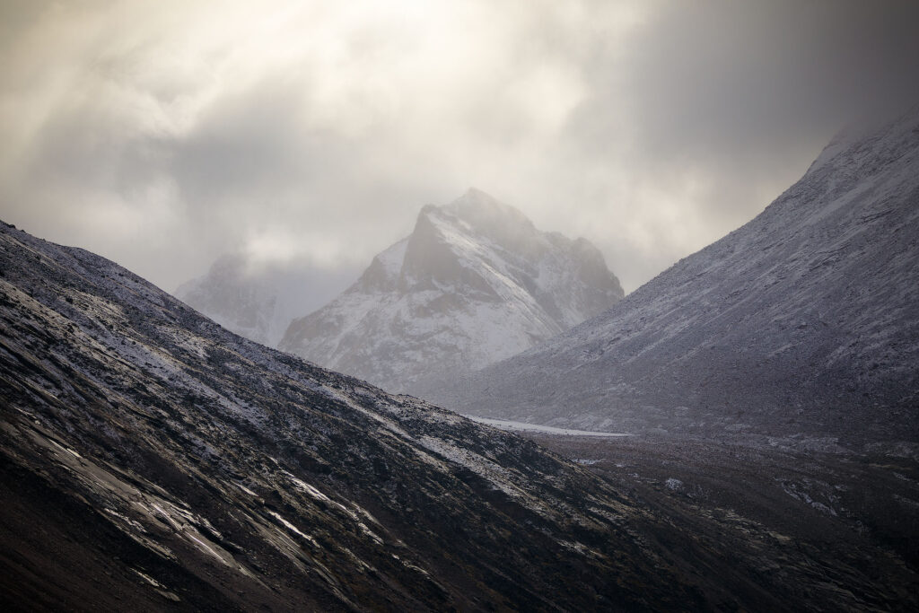 golden cloudy light over arctic peaks