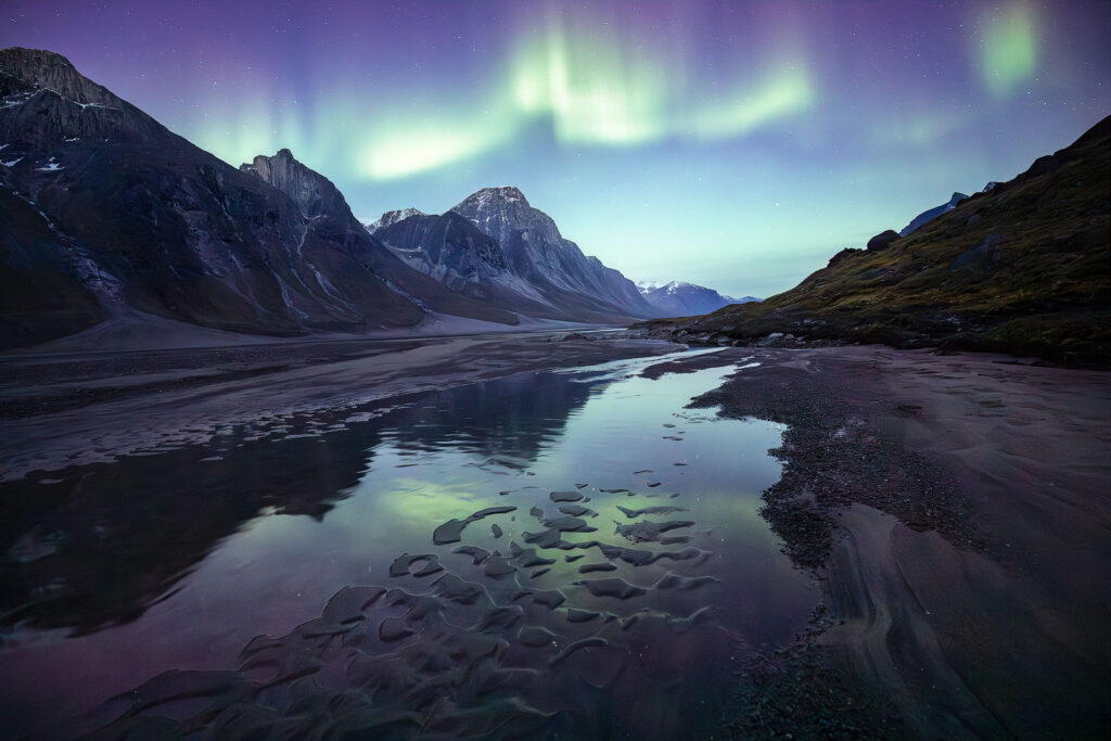 northern lights over arctic river valley