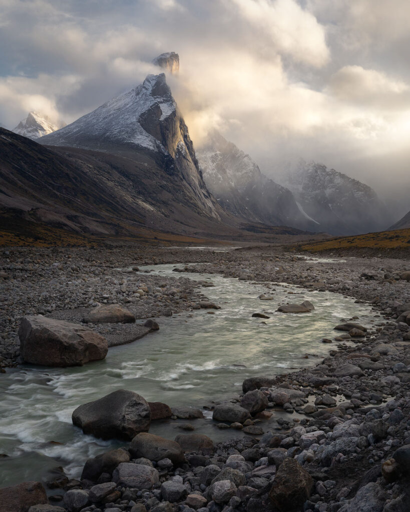 Towering Mount Thor breaks through clouds